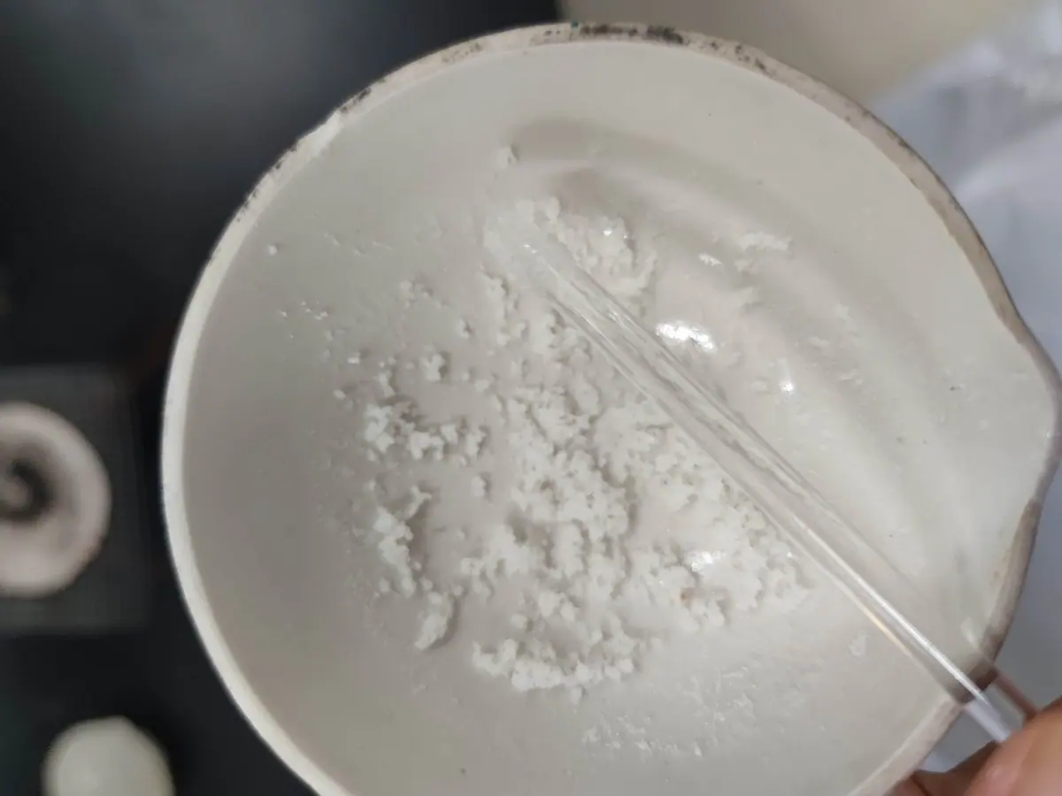 White powder or residue inside a small container.