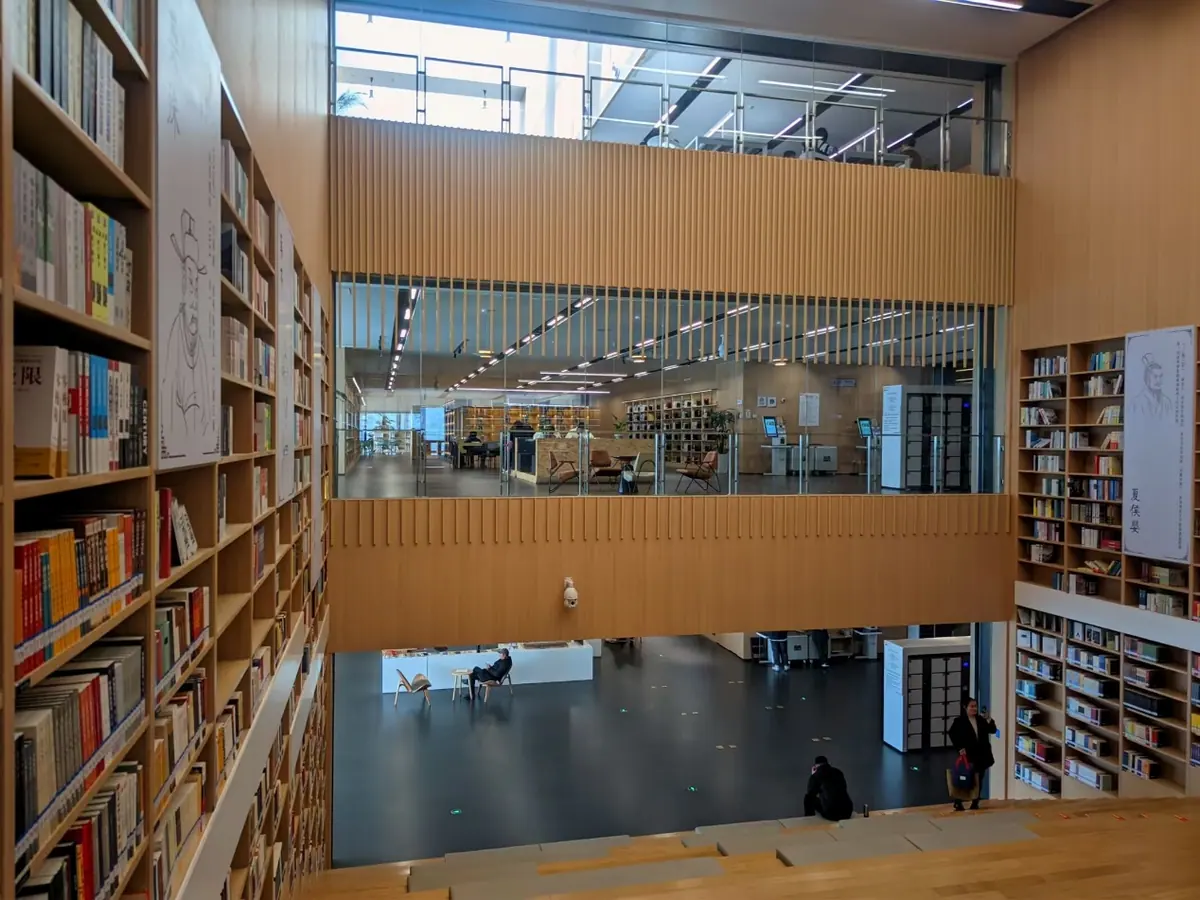 The interior of a library or bookstore with bookshelves and open space.